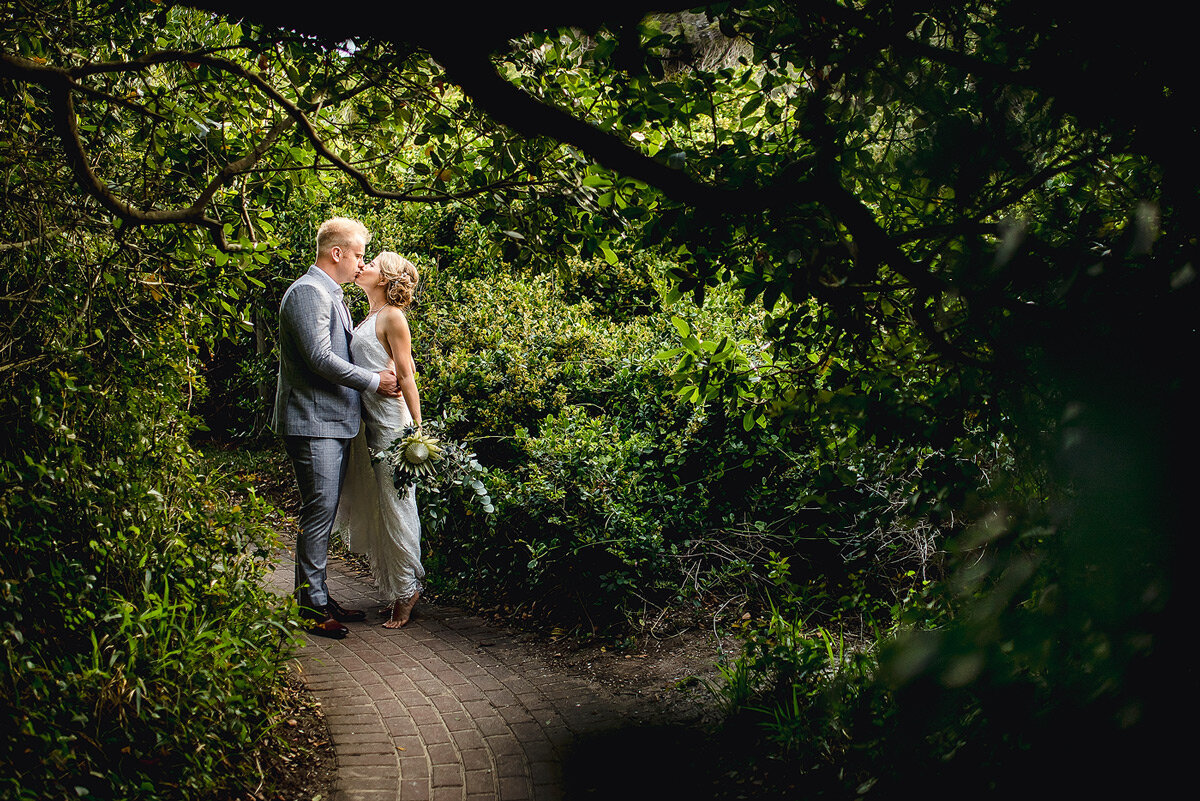 Plettenberg Bay Wedding Couple Portraits between lush greenery near the beach at the coastal town.