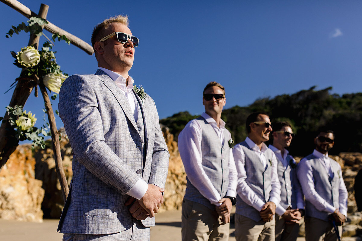 Groom reaction to his bride walking down the aisle at their beach wedding in Plettenberg bay.