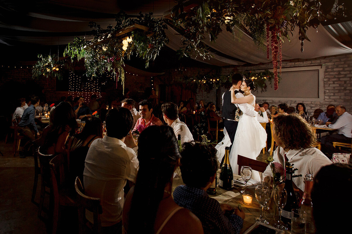Bride and groom first dance with floral wedding decor in the foreground at a Garden Route wedding.