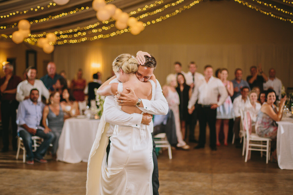 Wedding First Dance moves with guests looking on.