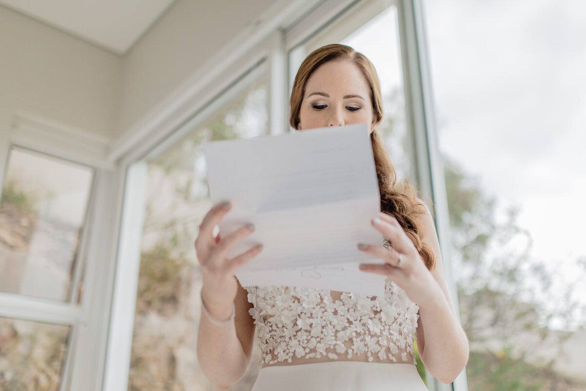 Emotional Bride reading a letter before a wedding in Plettenberg Bay