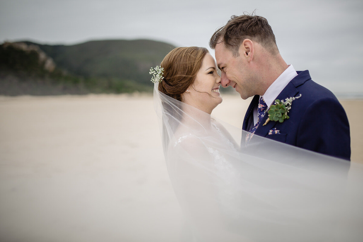 Wedding couple photos with veil on the beach in Natues Valley near Plettenberg Bay.