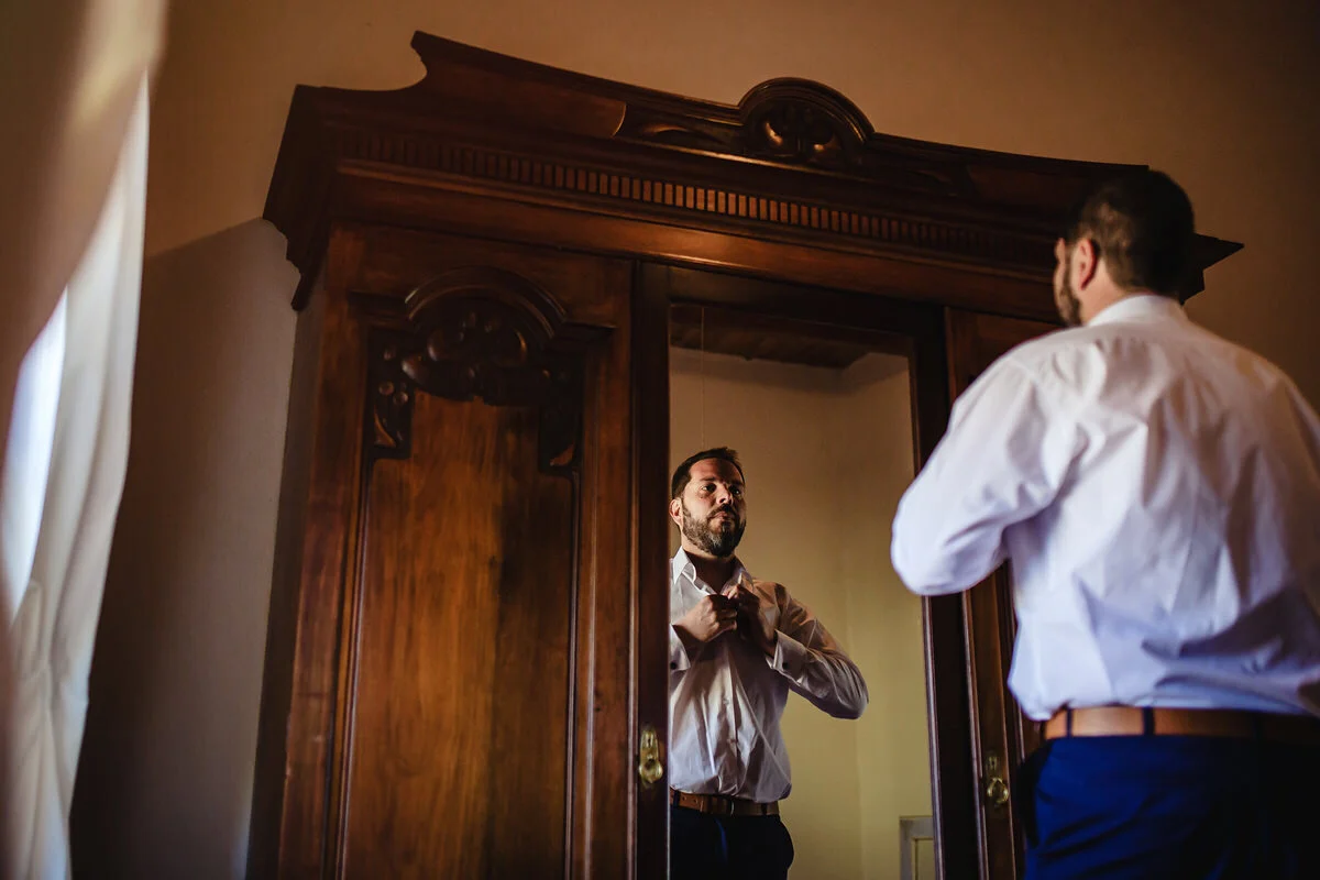 Groom getting dressed with his wedding suit at a Karoo wedding.