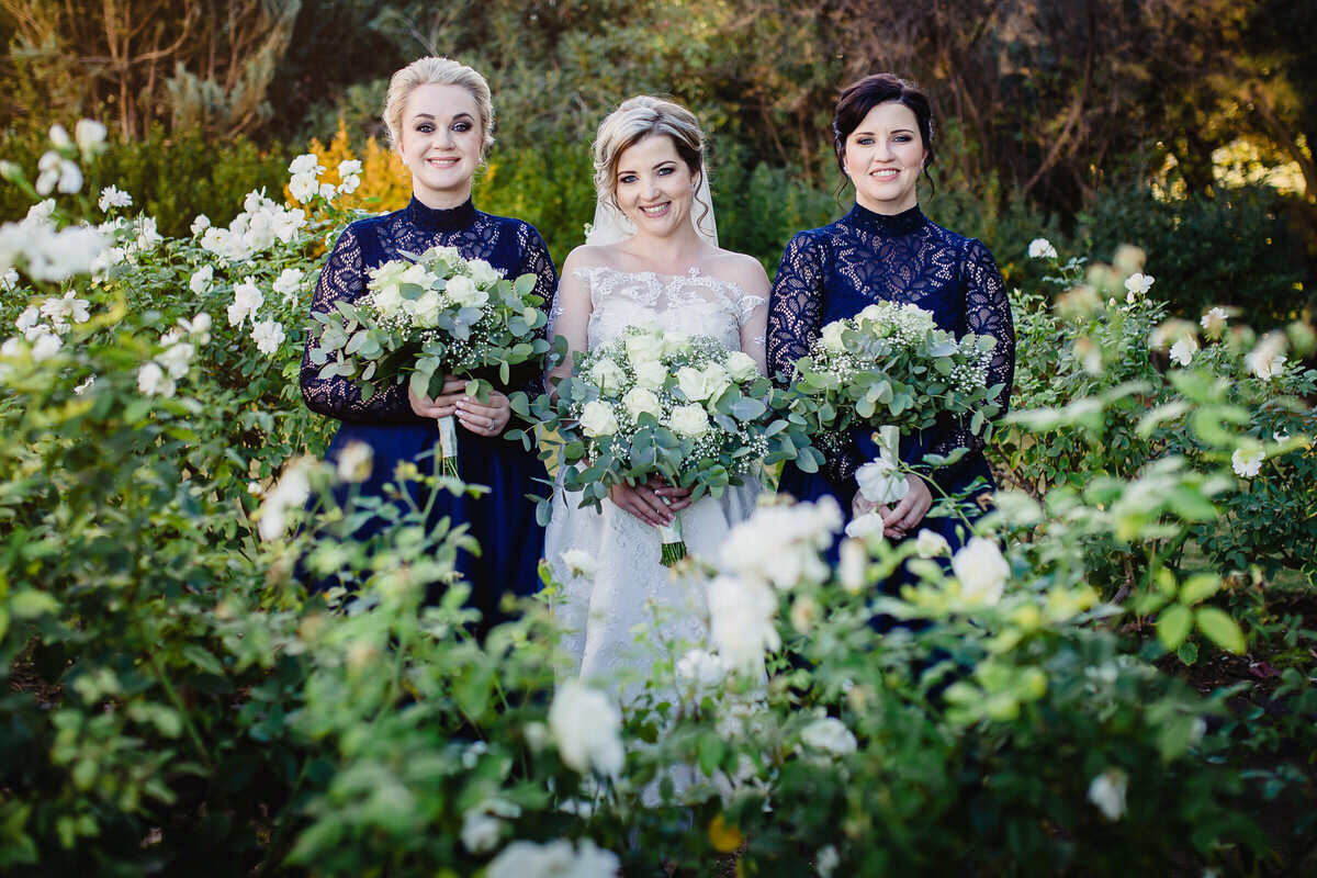 Bride and Bridesmaids portraits in roses and winter wedding dresses.
