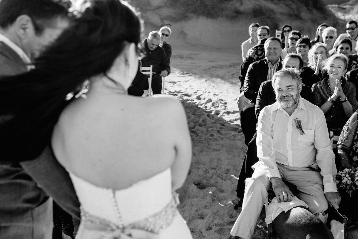 Father looking at daughter during beach wedding in the Garden Route.