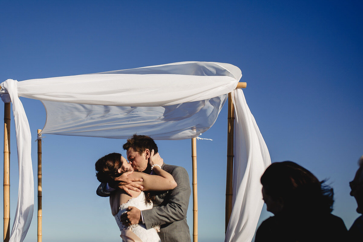 An elaborate wedding kiss during the beach wedding ceremony in the Garden Route.