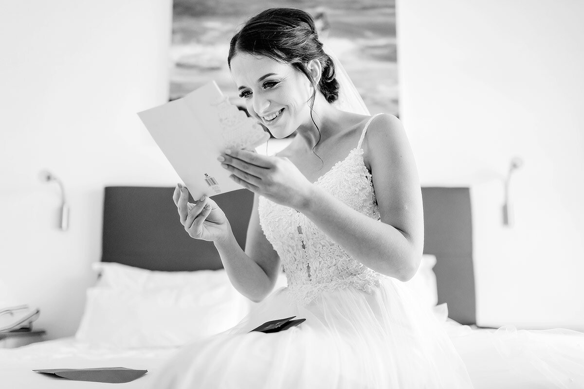 Bride reading a letter from her Groom before the wedding ceremony.