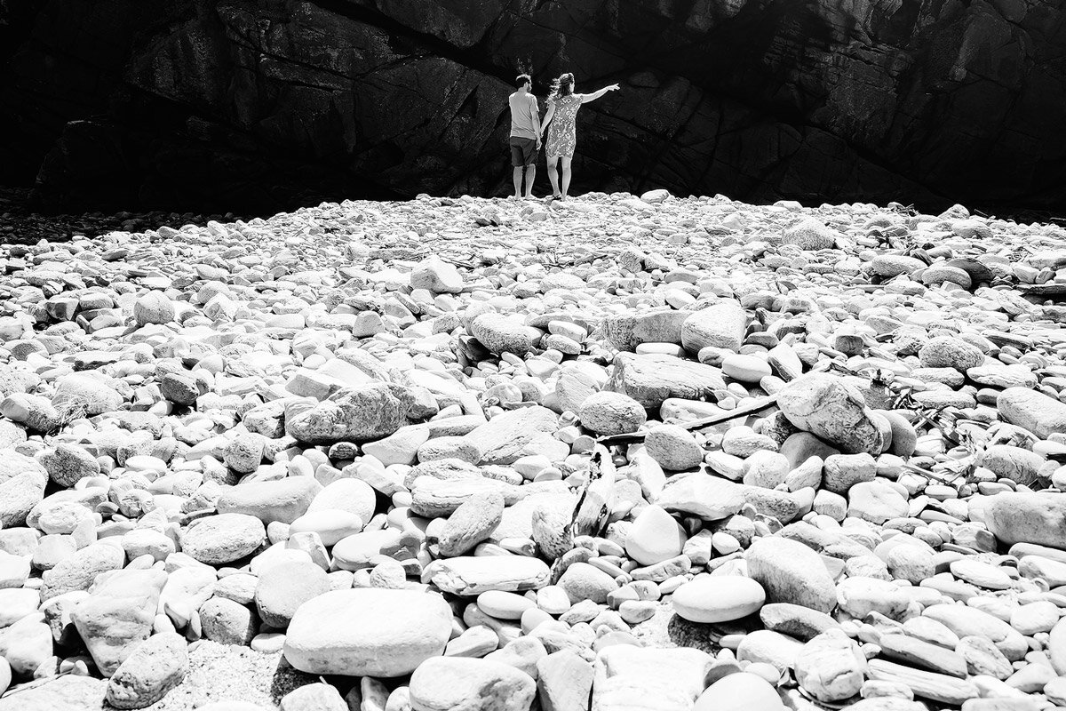 Couple exploring Ballots Bay Beach in the Garden Route of South Africa.