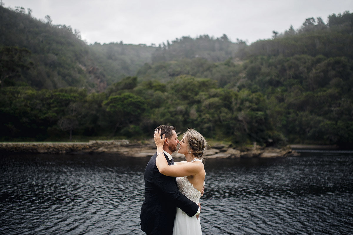 Wedding Couple Portraits on the pebble beach in Kaaimansriver near Wilderness in the Garden Route.