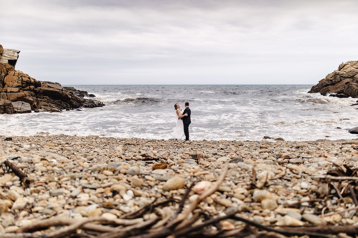 Wedding Couple Portraits on the pebble beach in Ballots Bay.