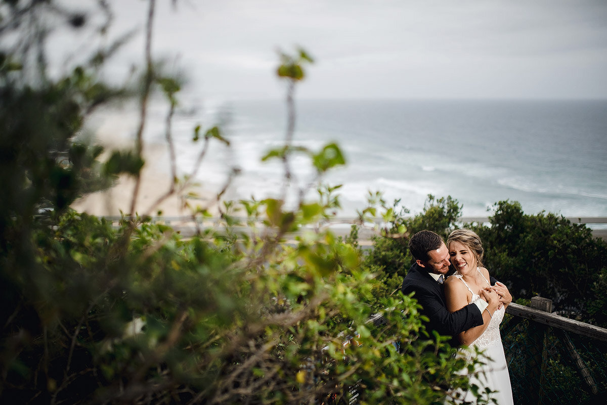 Wedding Couple Portraits on the pebble beach in Kaaimansriver near Wilderness in the Garden Route.