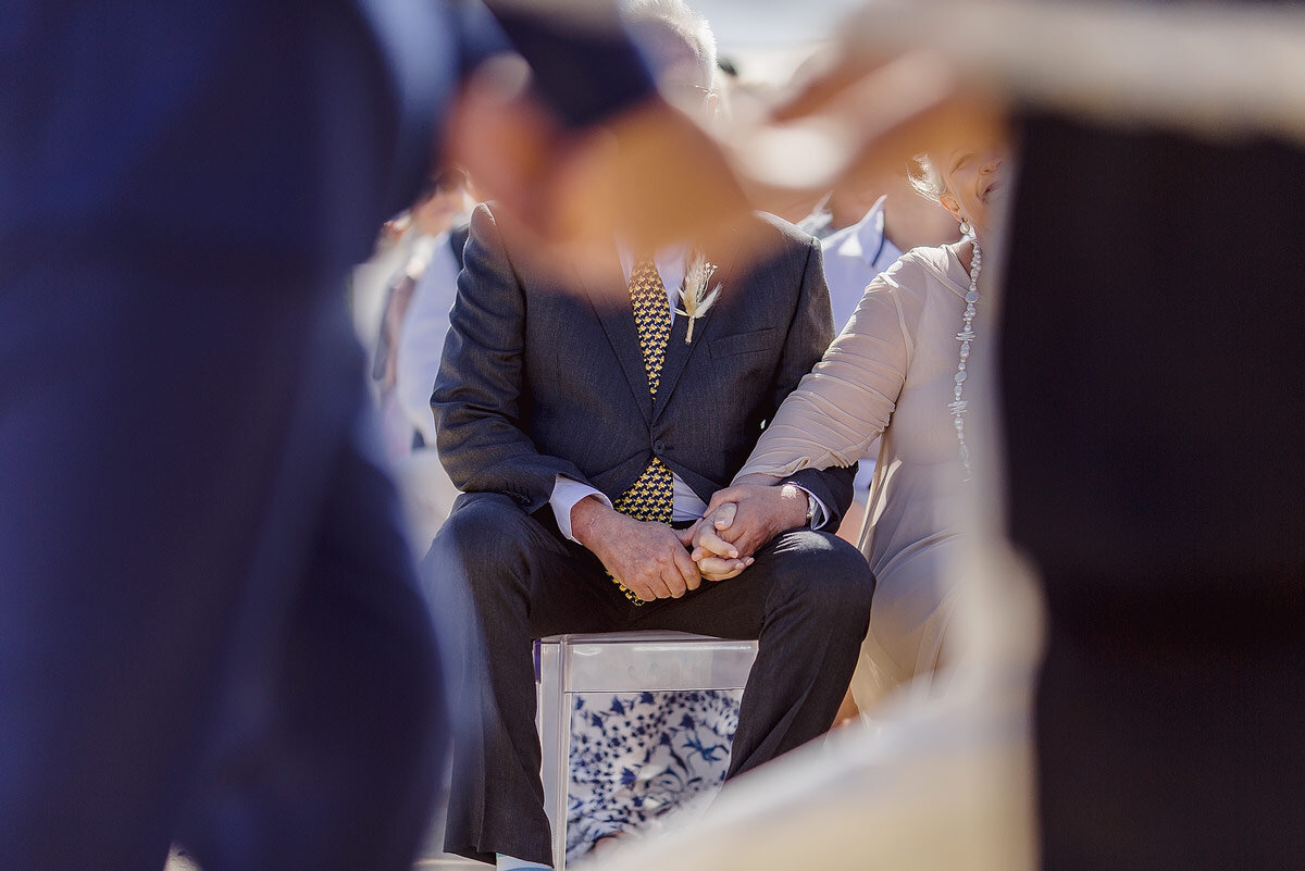 Father and mother holding hands at a Garden Route Beach Wedding.