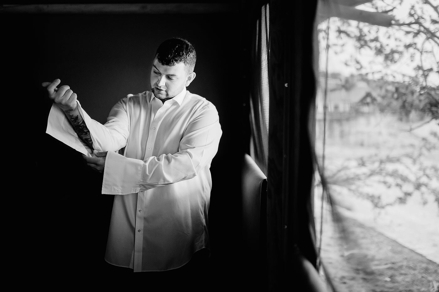 Groom getting dressed before the wedding  ceremony.