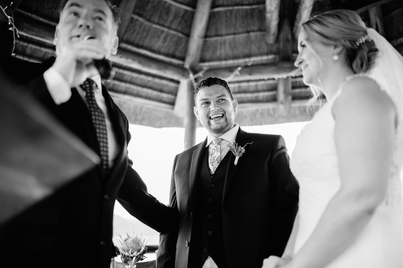 Groom reacts to a joke  made by the wedding officiant. 