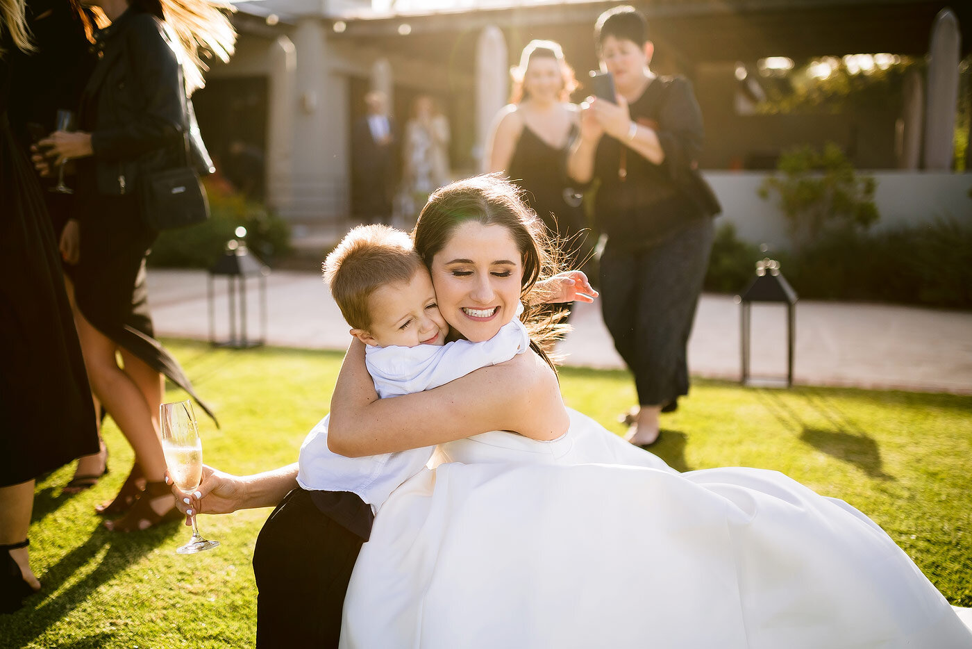 Bride embraces her son at the wedding reception.