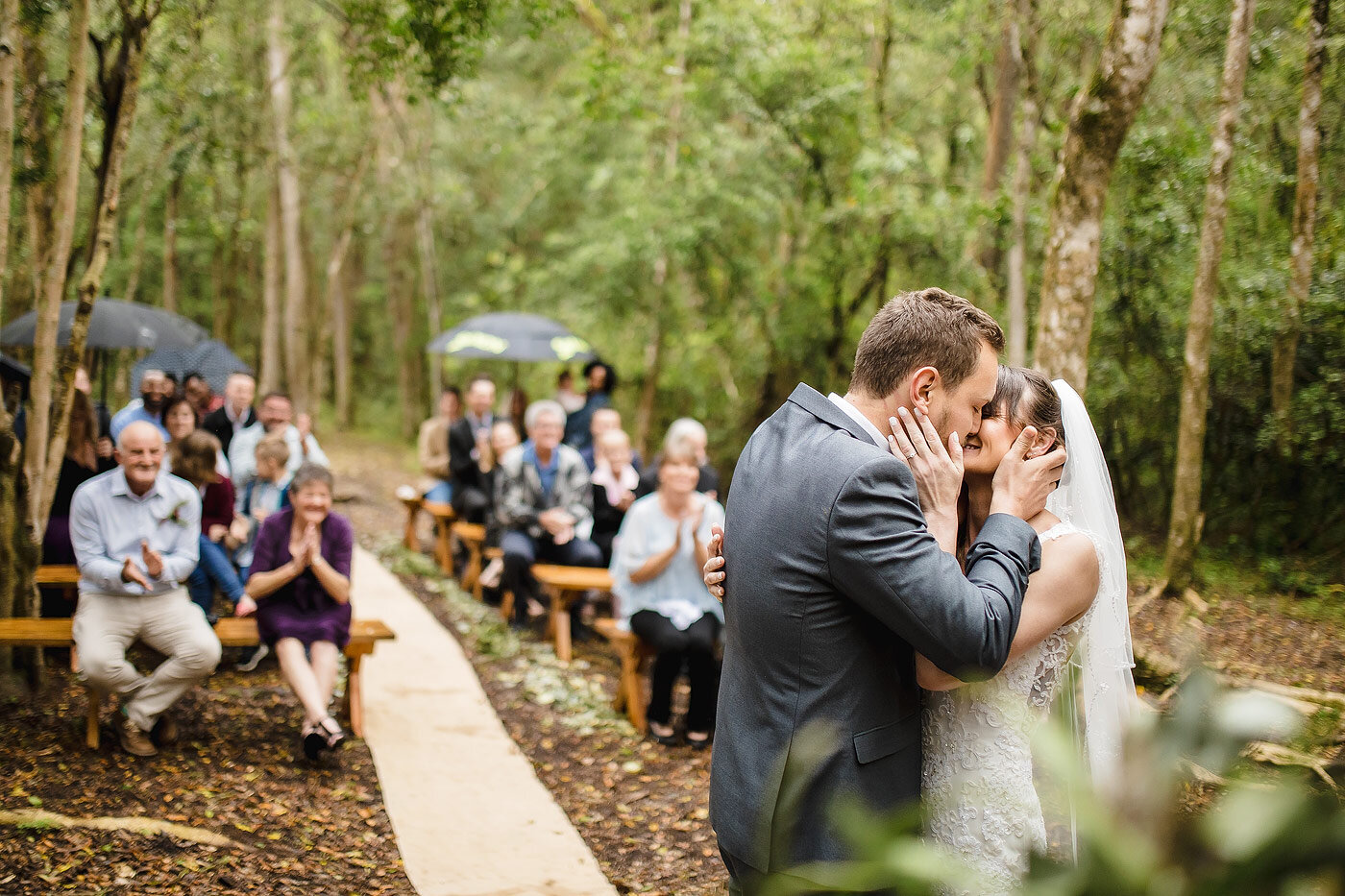 Bride and groom kiss during a forest wedding in the garden route.