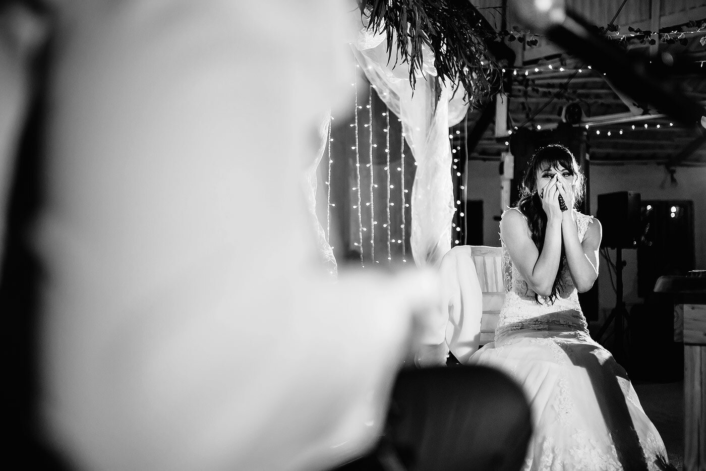 Bride reacting to the groom playing her a personal wedding song.