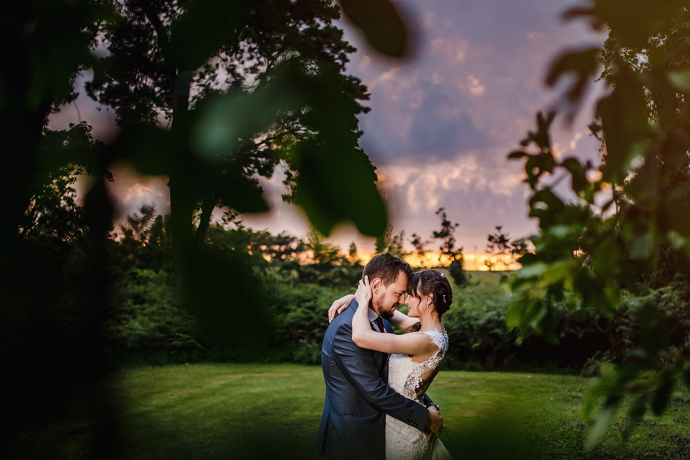 Bride and groom sunset wedding portraits during golden hour.