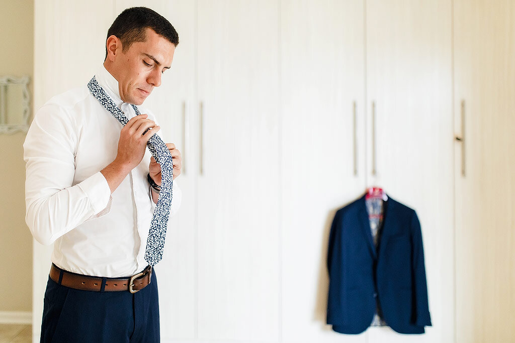 Groom putting on his Tie