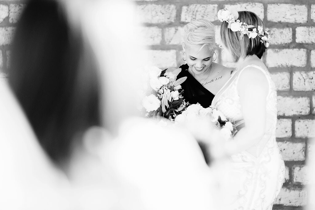 Moment between two brides during wedding ceremony