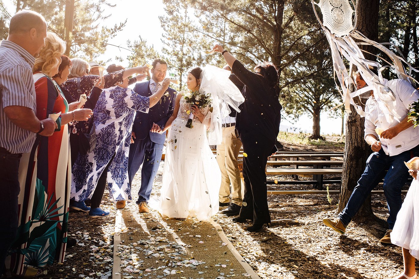 Bride and groom with flower petal confetti