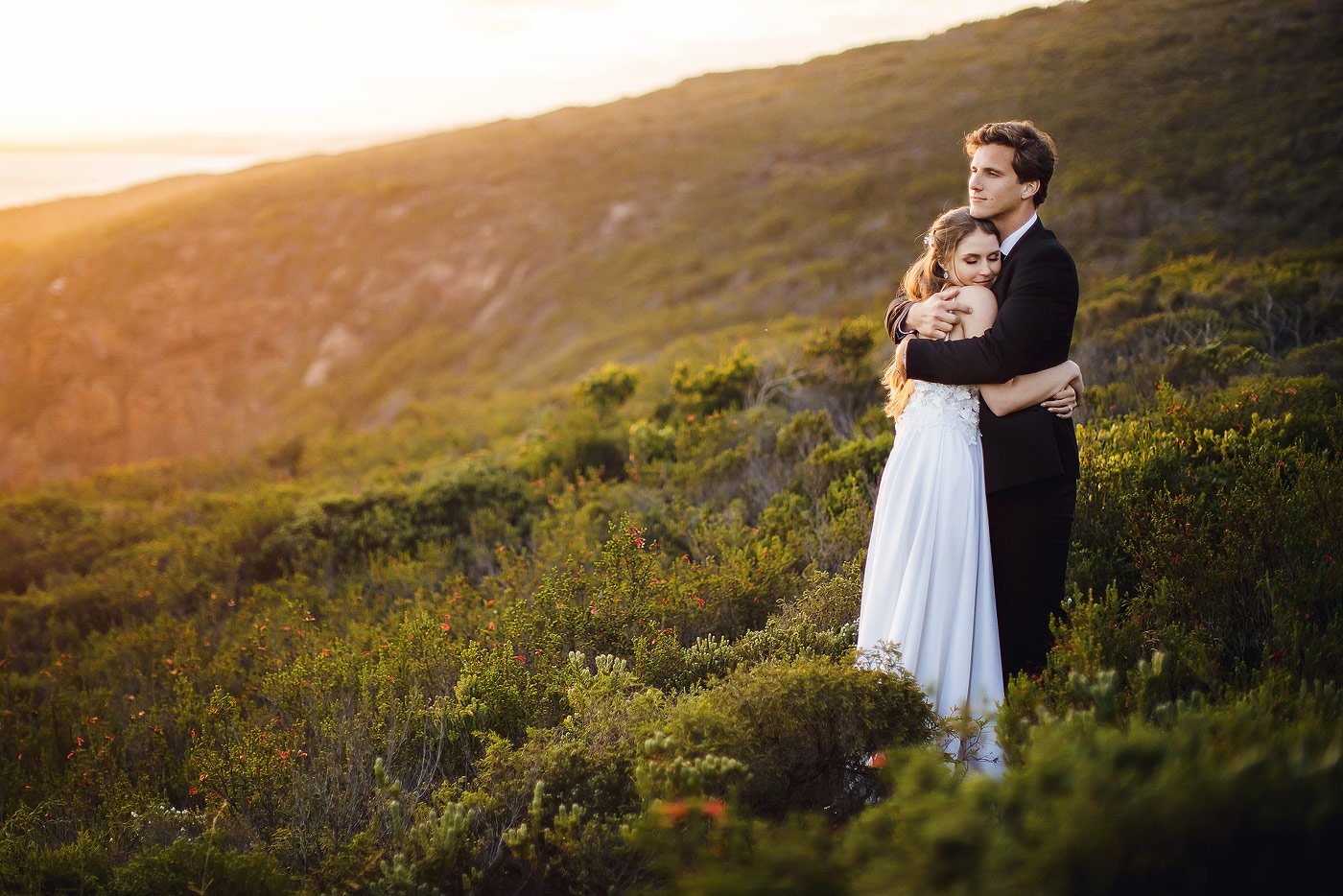 Sunset wedding portraits at the beach in Herold’s Bay with Devon and Jessica after a day of seasonal rain in the Garden Route. 