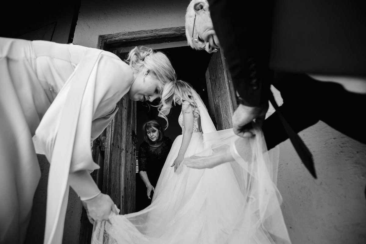 Family helping the bride with her wedding veil.