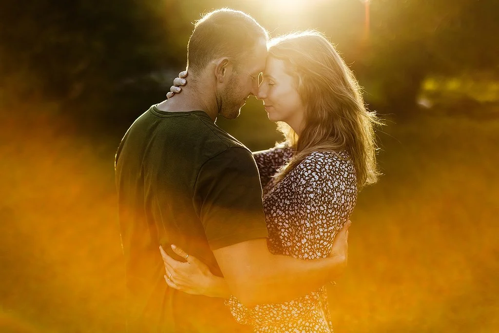 Romantic Couple Photo at Sunset in an open field.