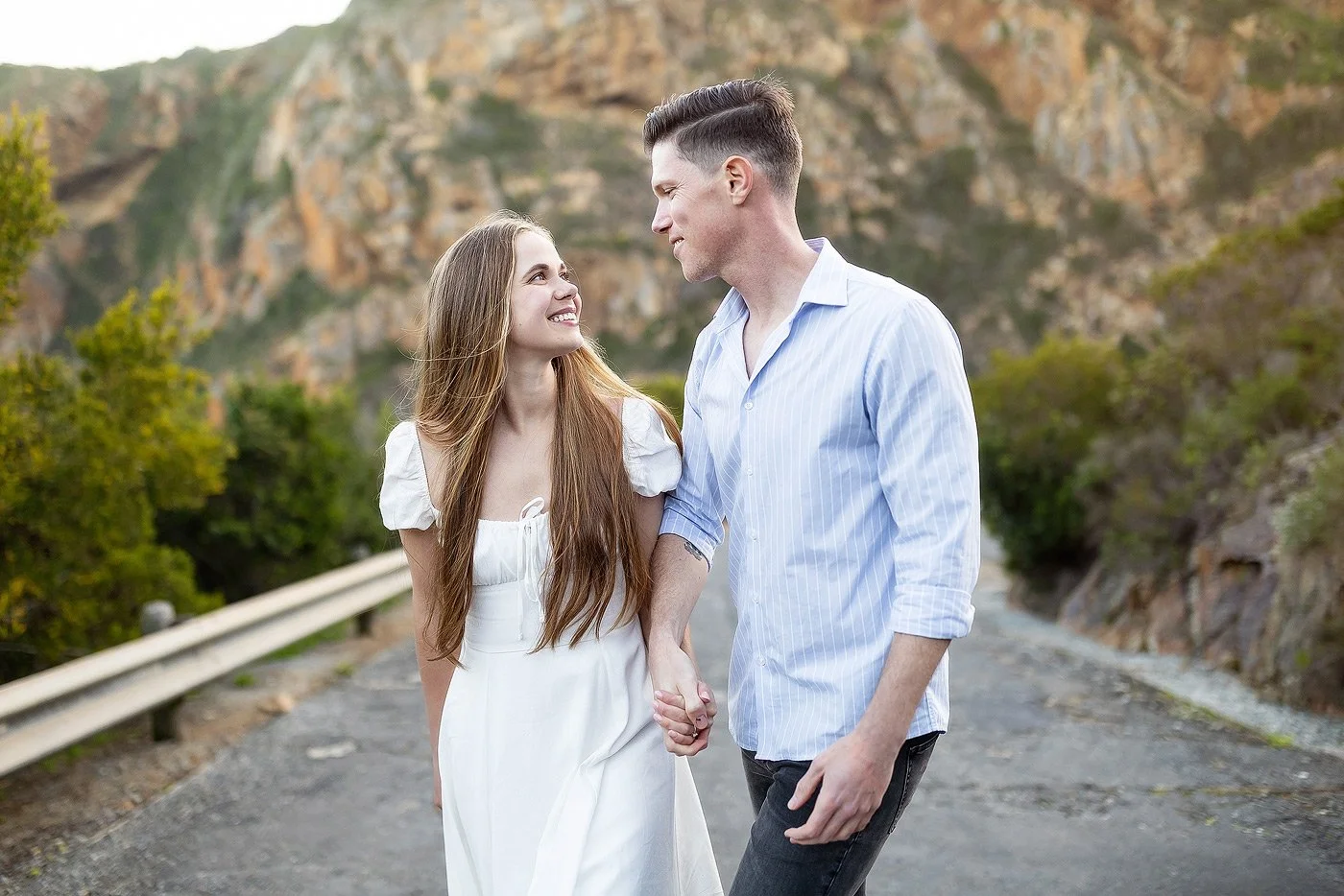 Couple walking up a hill during their engagement couple shoot in George.
