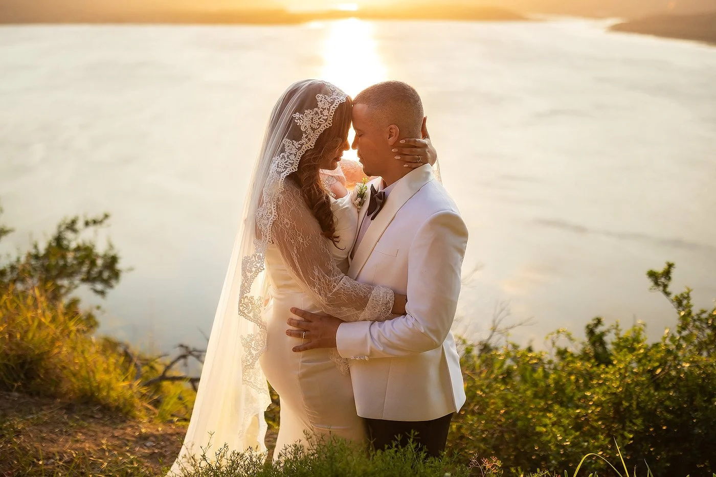 Wedding Couple at Sunset with lake in the backround.