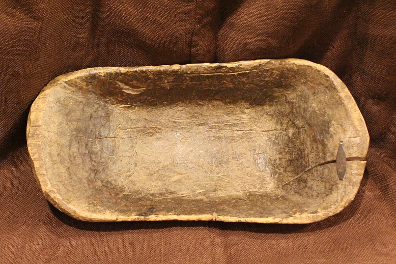 Notice the many imperfections in the craftsmanship, and how a large crack lovingly repaired with a metal fastener (which might make some want to throw it out altogether) lends this bowl cherished character.