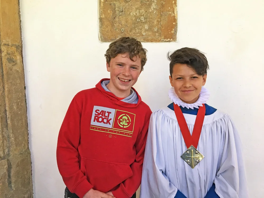 Outgoing Head Chorister Taylor (left) hands on the baton to his successor, Xavier