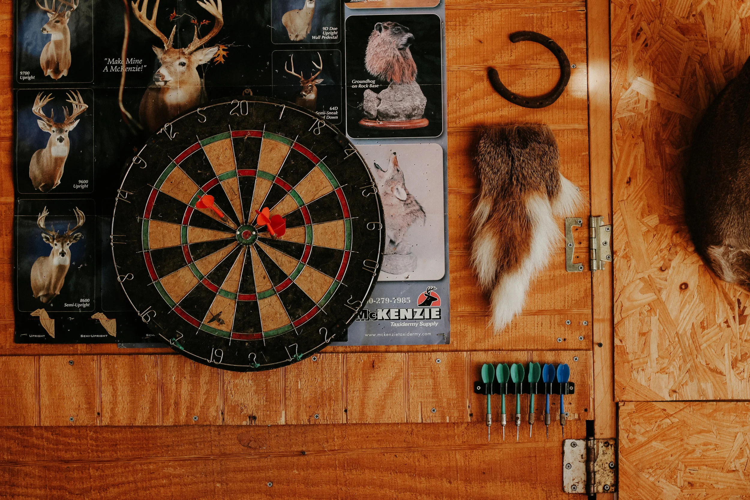 A dart board hangs on a wall in Sherman's shop.