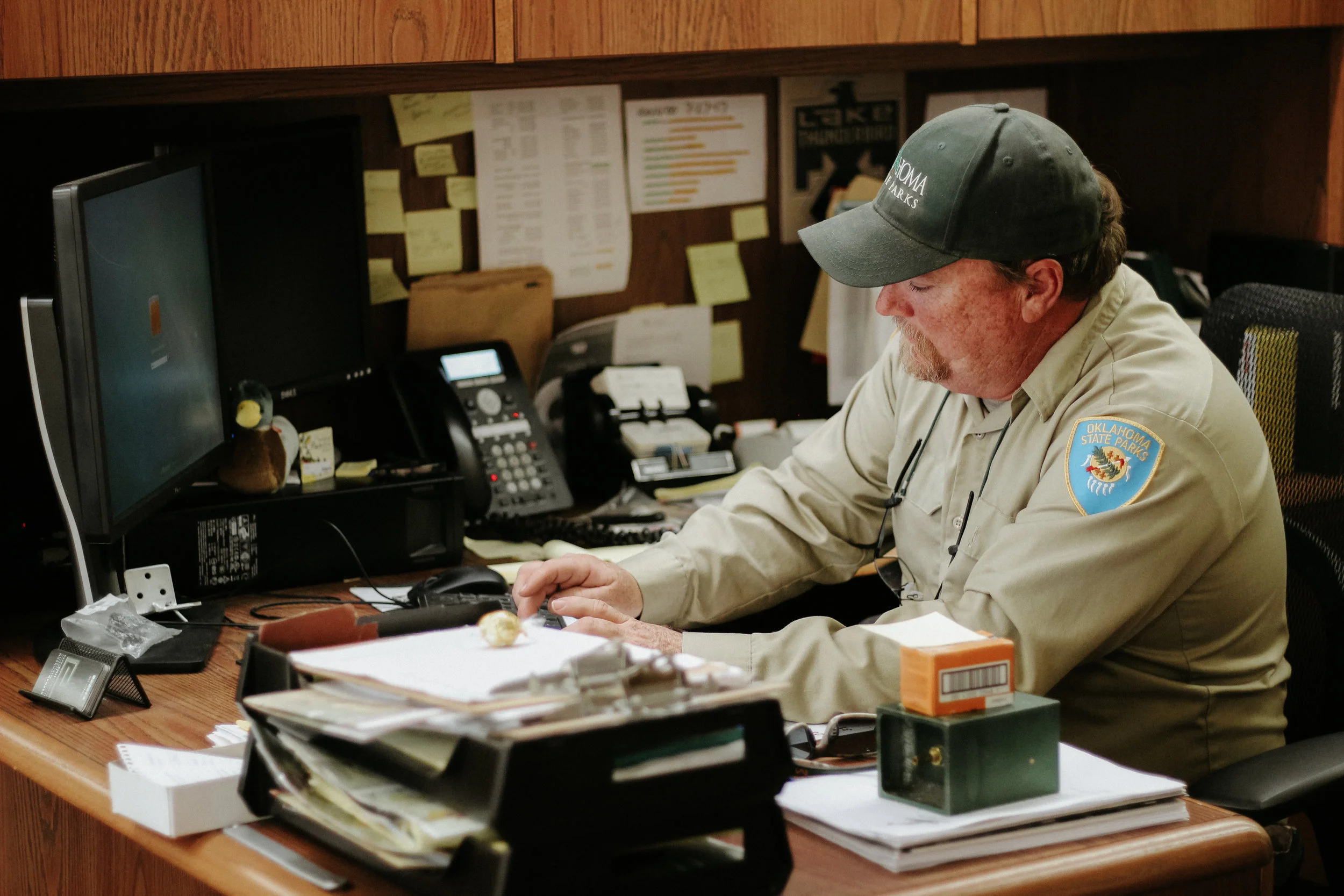 Sherman works at his desk in the Lake Thunderbird State Park offices.