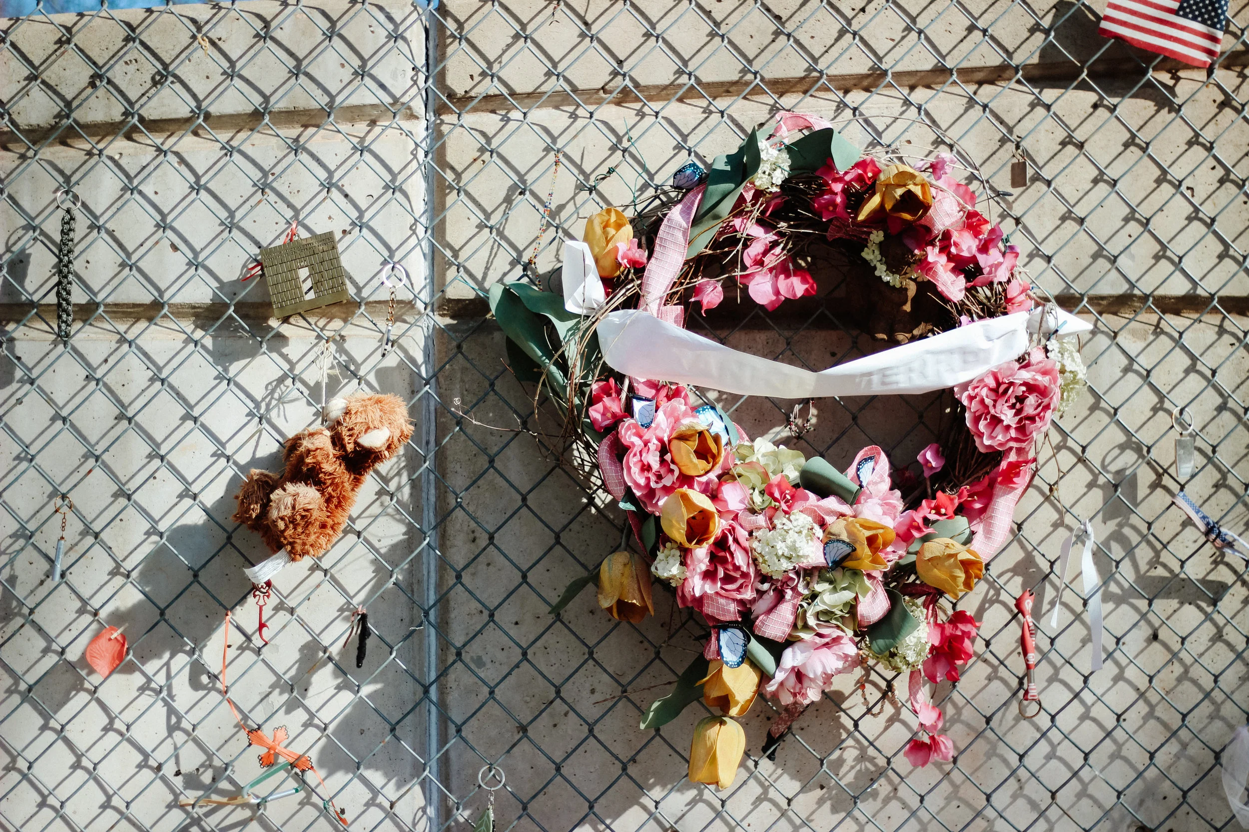 Items of personal significance are hung from the chainlink fence at the Oklahoma City National Memorial.