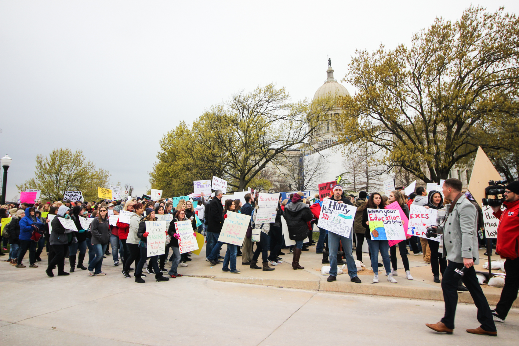 Demonstrators march around the Oklahoma State Capitol.
