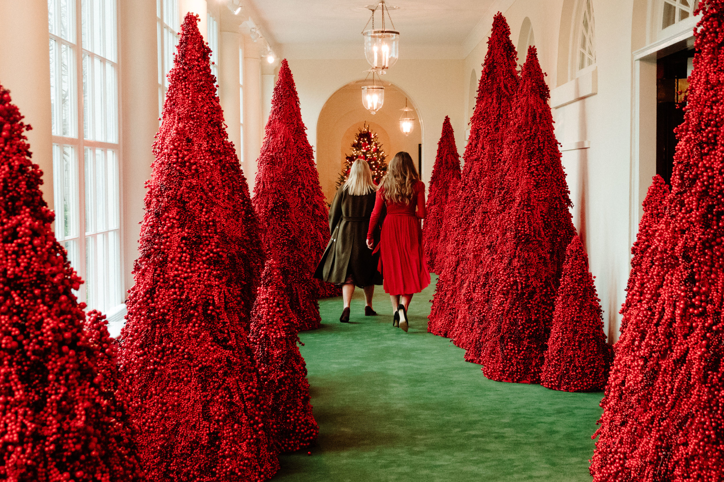 A pair of women walk down the freshly-decorated Ground Floor Corridor in the East Wing of the White House in Washington, D.C. on November 25, 2018.