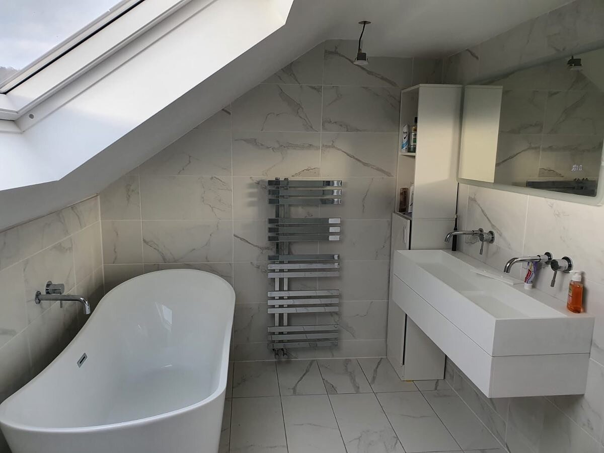 Current en-suite being finished. Sleek marble floor and wall tiles. Floating vanity and chrome taps and radiator. #carpentry #carpenter #ensuite #loft #conversion #loftconversion #bathroom #shower #toilet #bath #relax #chislehurst #sevenoaks #bromley