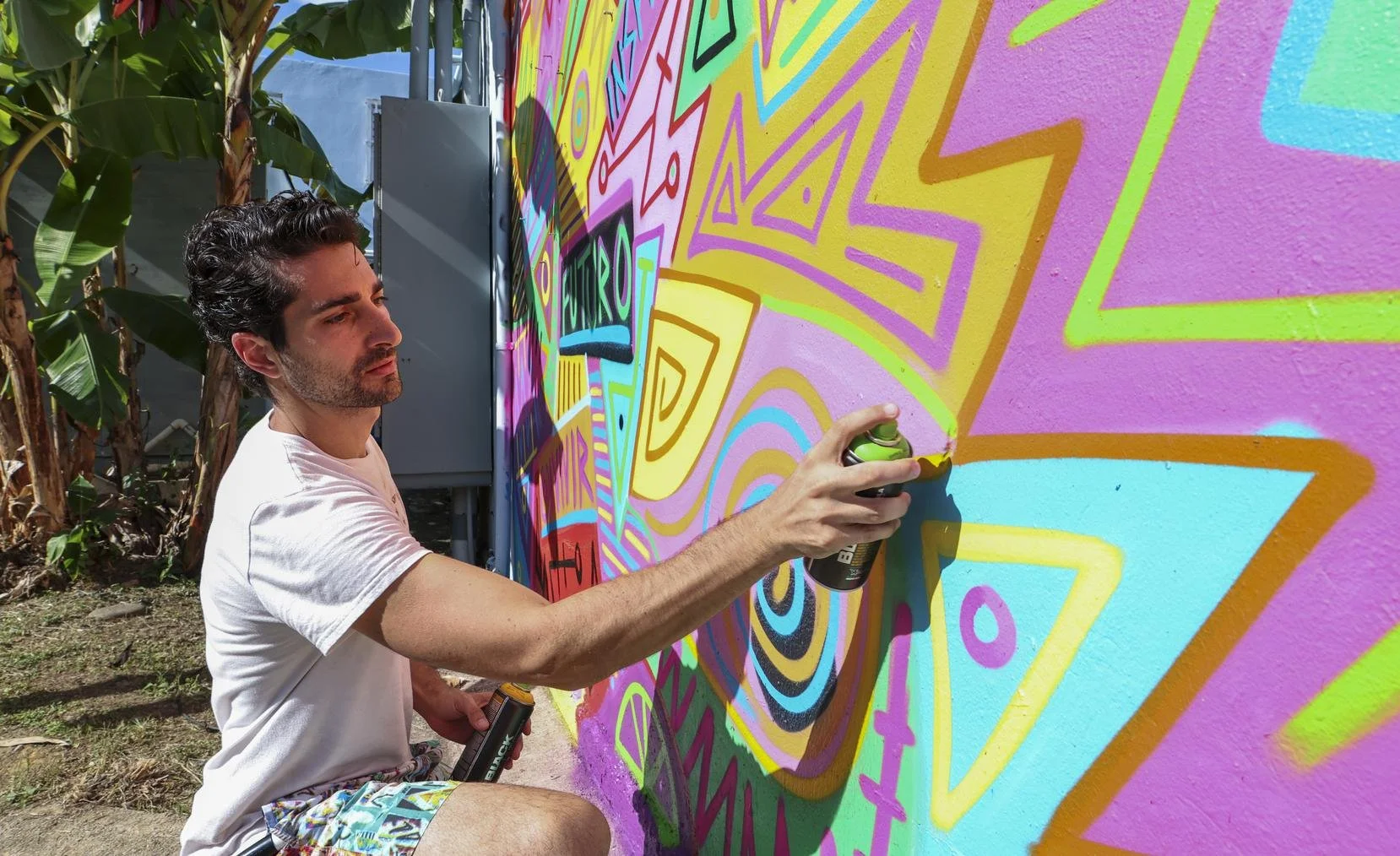 Marco Santini painting Aspira School Mural in Puerto Rico.jpeg