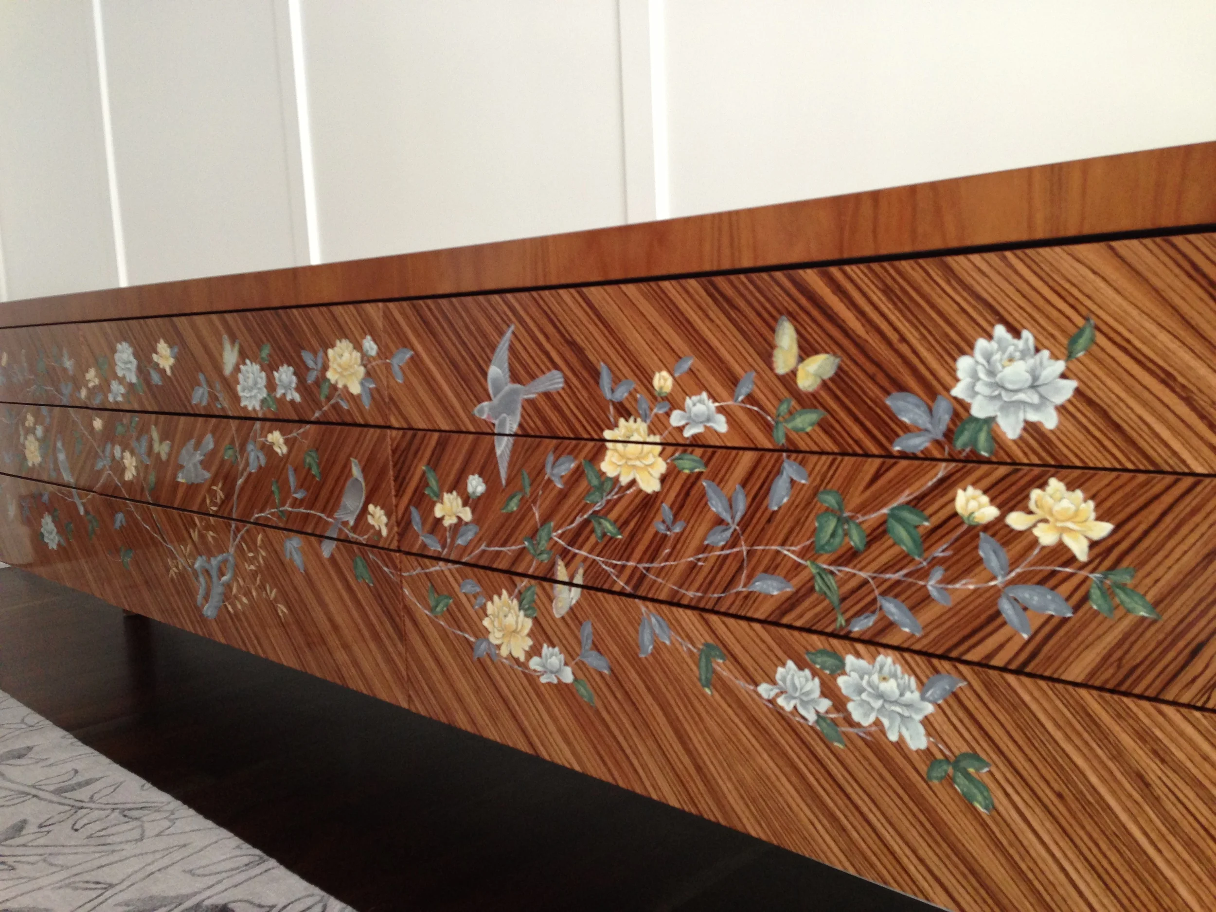 chinoiserie inspired painting on zebra wood buffet