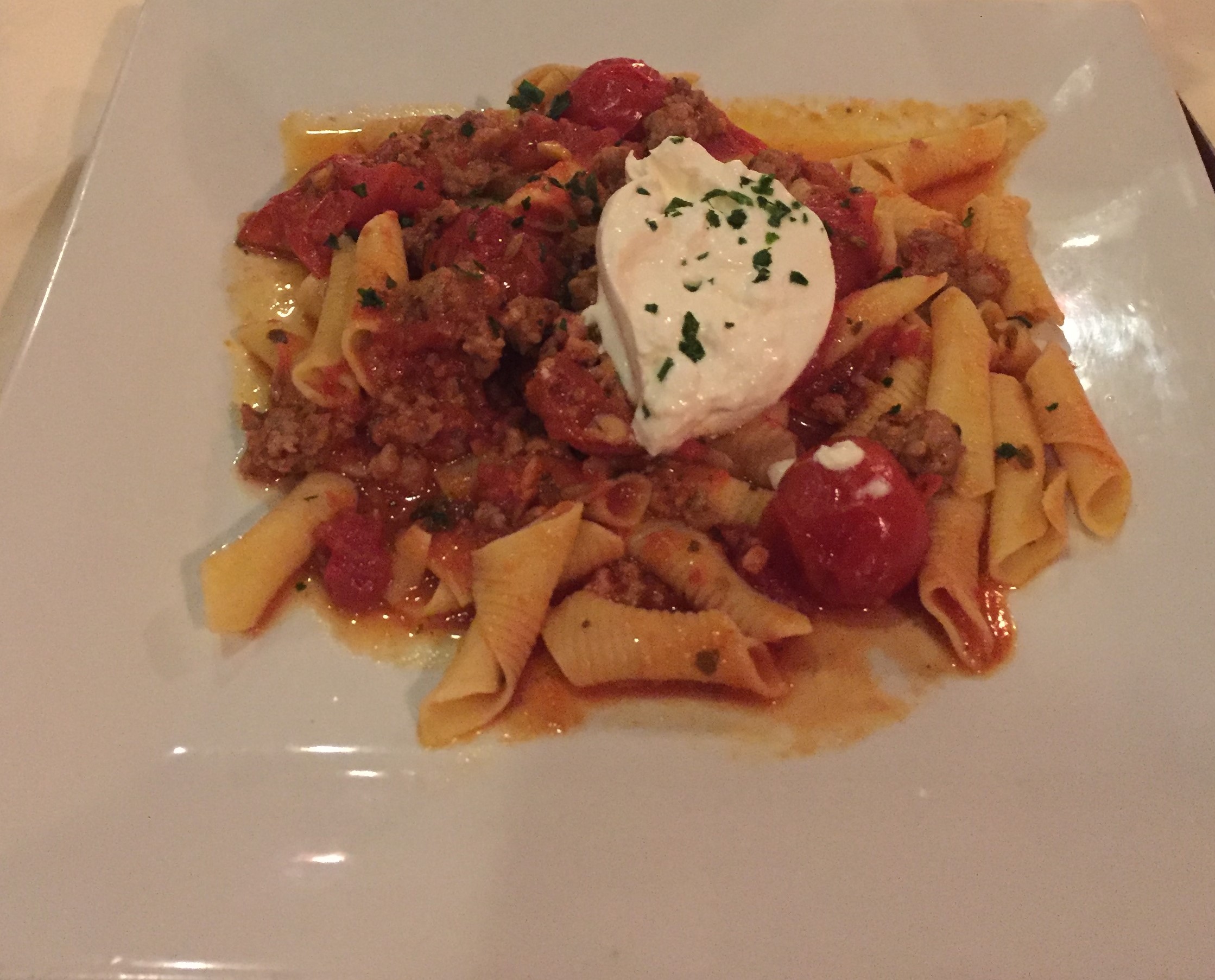 Homemade Garganelli with spicy Italian sausage, roasted tomatoes and Burratta