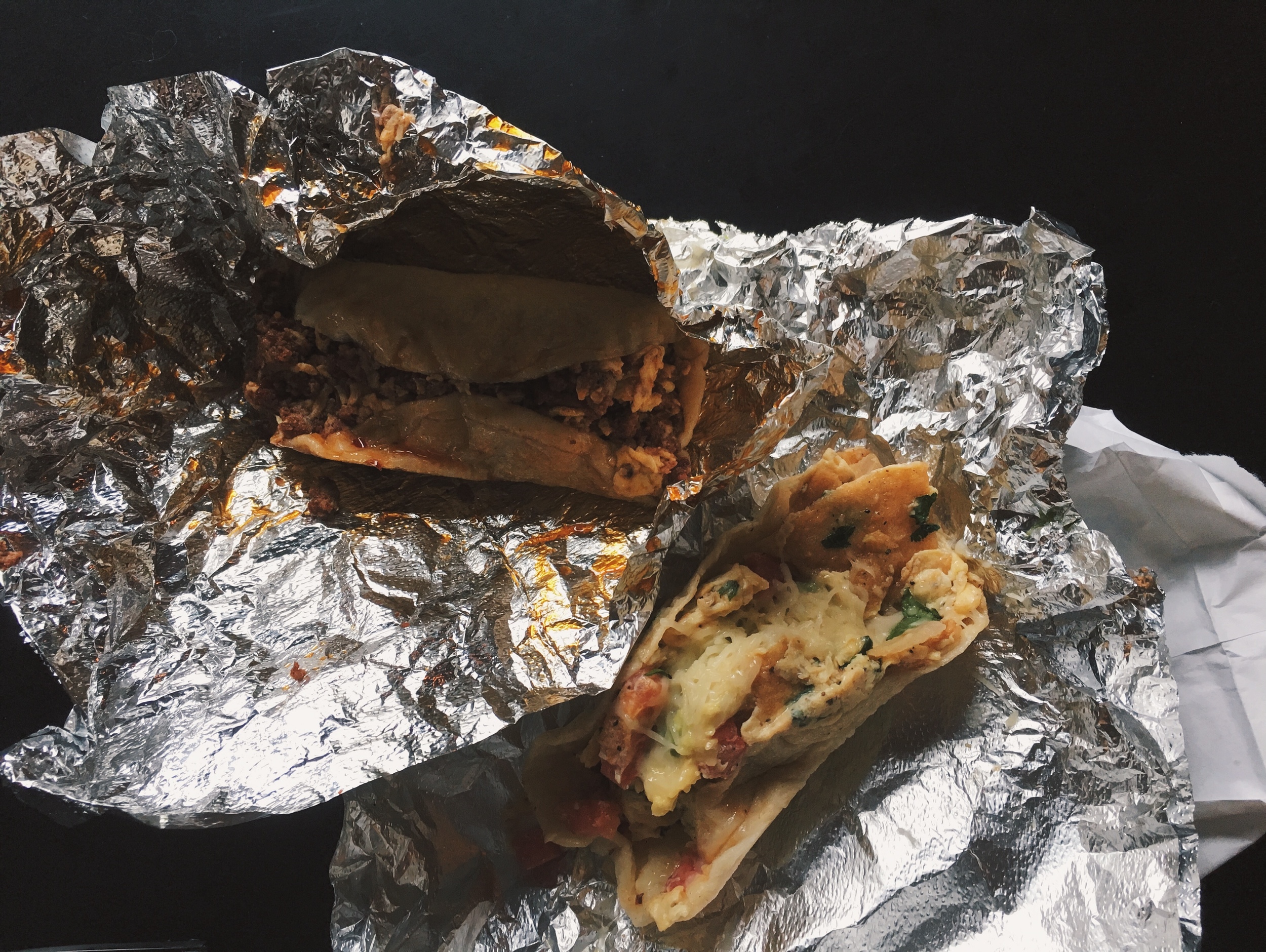 The chorizo, egg, and cheese taco (L), and the migas taco (R), ready for eating in the neighbouring Radio Coffee. Small businesses on the same lot often partner in Austin, to promote themselves simultaneously. 