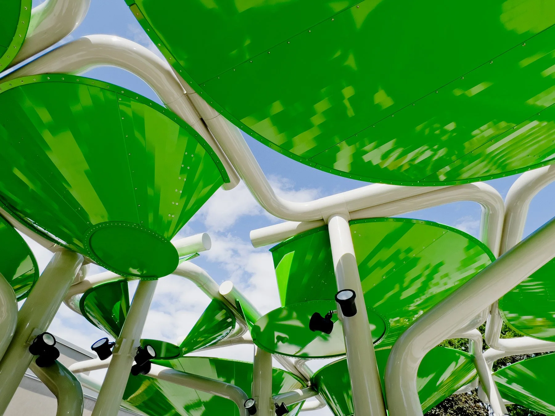 centennial-commons-pavilion-exterior-detail-green-curved-metal-panels-bent-steel-tubes-royal-oak-michigan-deleon-primmer-dpaw.jpg