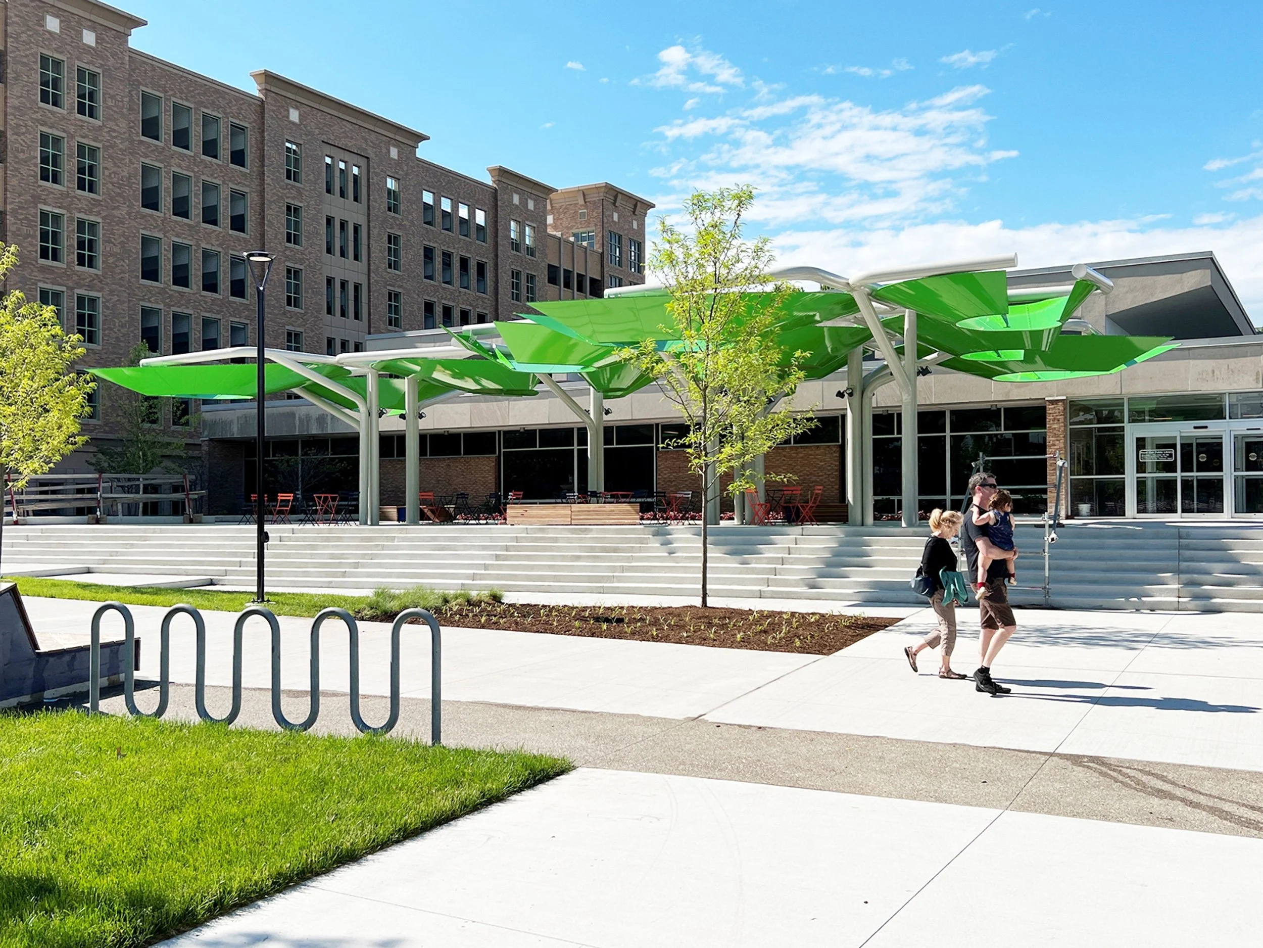 centennial-commons-pavilion-exterior-plaza-green-curved-metal-panels-canopy-bent-steel-tubes-royal-oak-michigan-deleon-primmer-dpaw.jpg