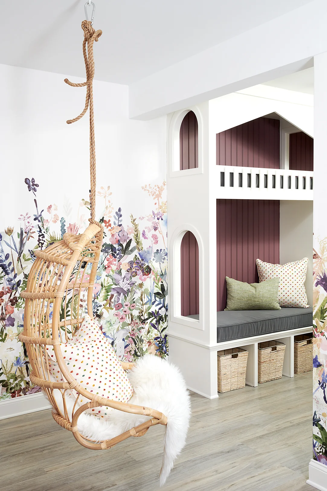 This hanging chair is placed in a perfect little nook by the playhouse for curling up with a good book, or just relaxing in, accessorized with a fluffy blanket and accent pillow.