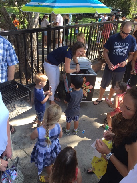 Mariana serving fruit bars and popsicles to excited kindergarten kids.