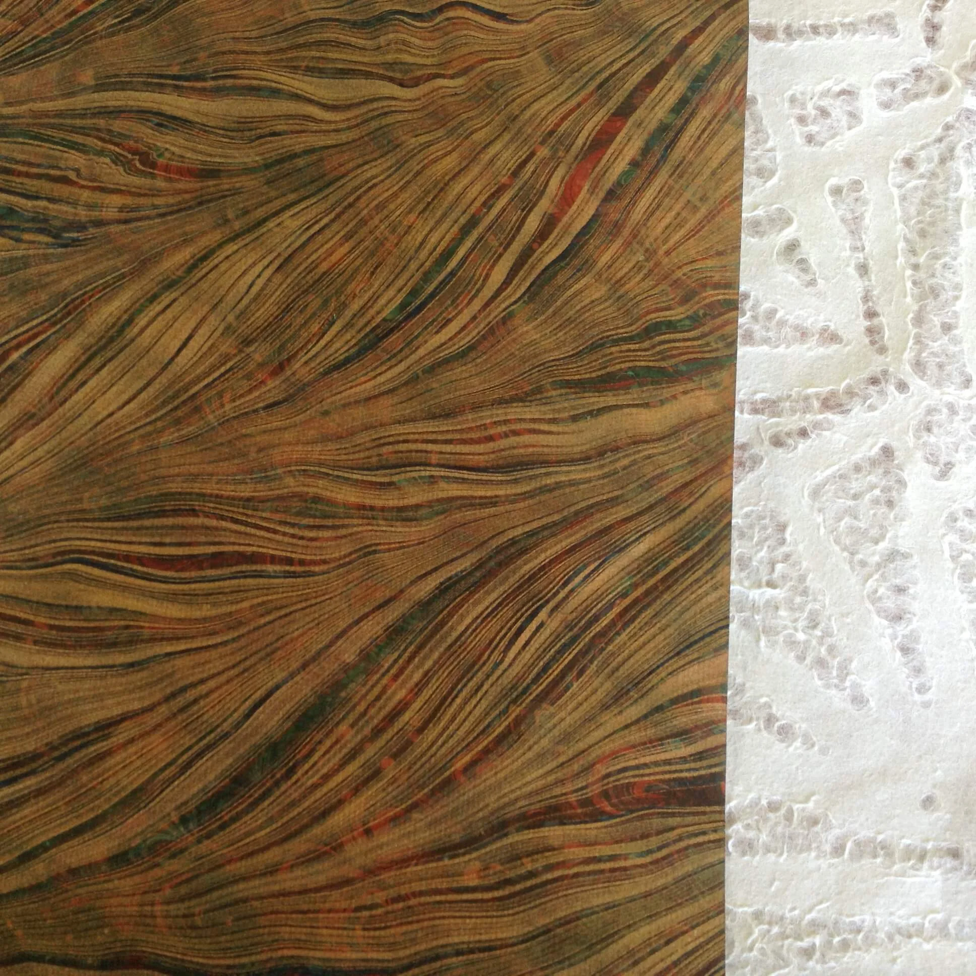 Contrasting papers, including a sheet of French double-marbled paper.