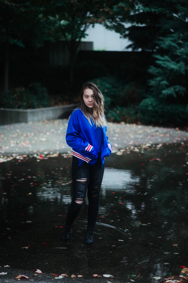 Girl Standing in Seattle rain puddle.