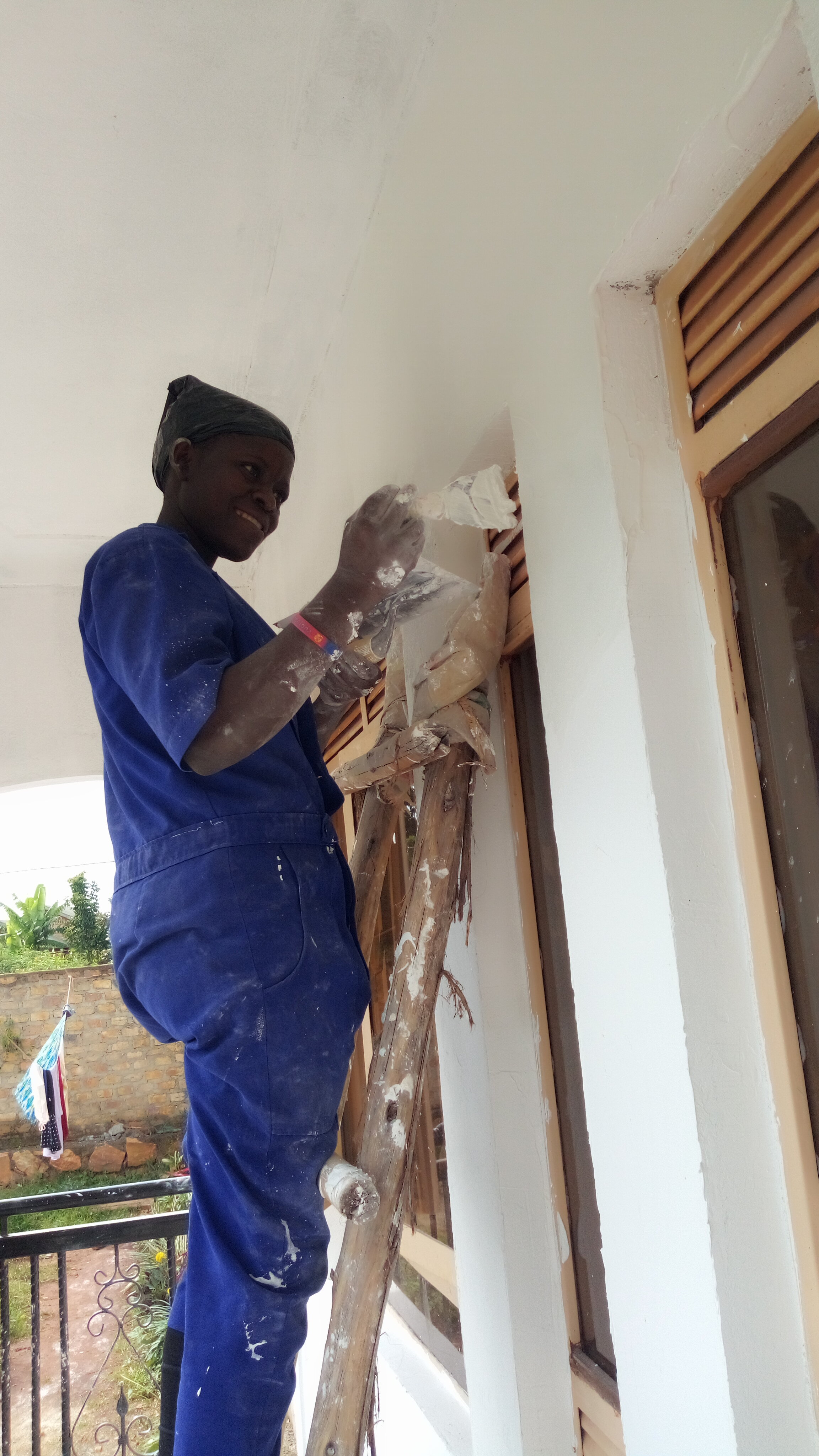  Mary, an EGI mom, at our vocational training school learning exterior painting. 
