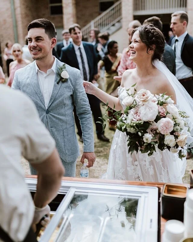 The newlyweds lining up for their ice cream post ceremony. We filled Kiah&rsquo;s bouquet with the most delicious summer garden roses and peonies! image by @angusmckernphotography